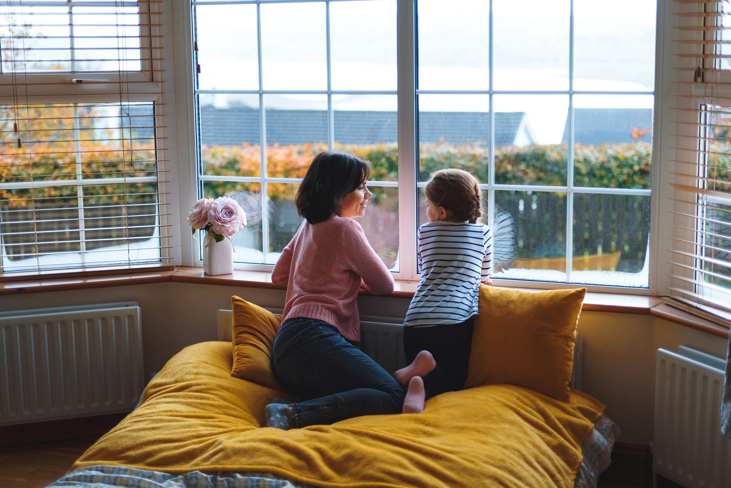 mother and daughter talking sitting at window in a house in Ireland